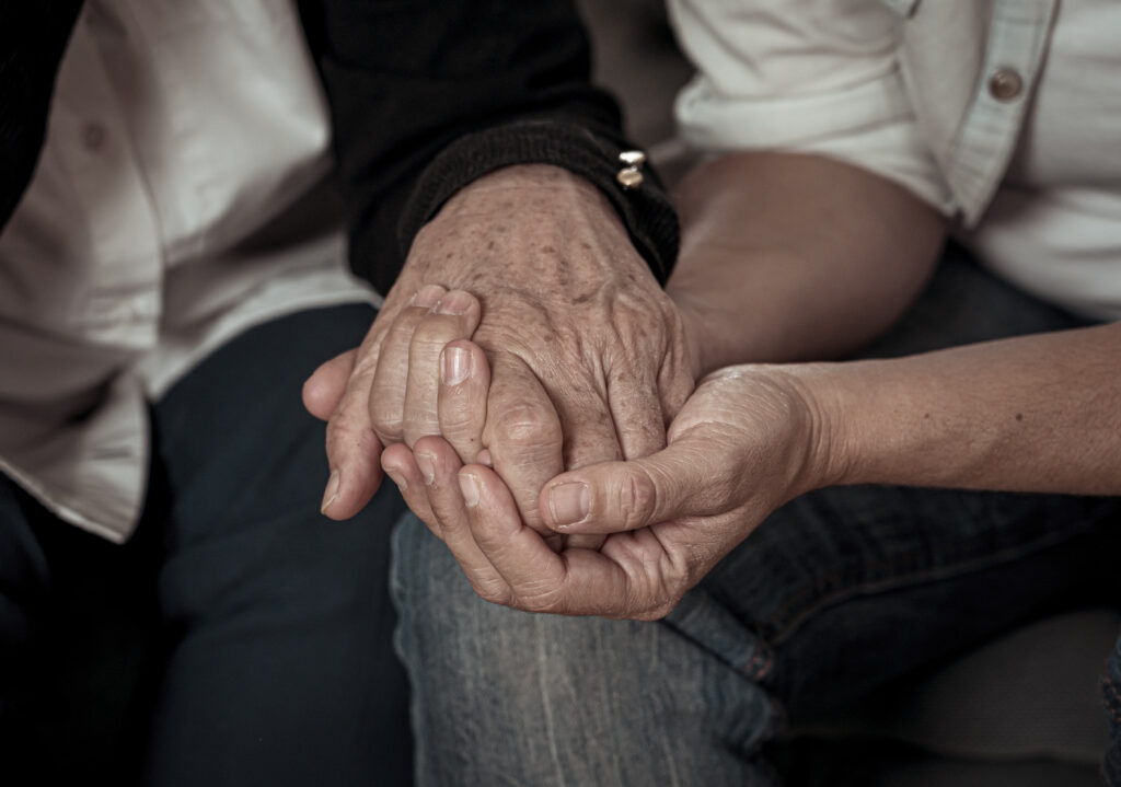 Hand holding Old Couple Curcio Law